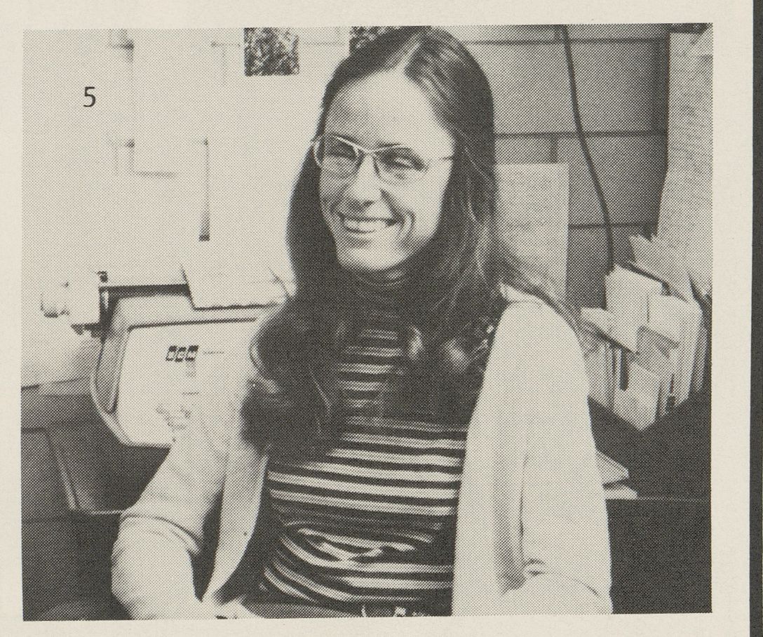 Black and white photo from 1983 of Maria Luisa "Weecha" Crawford smiling in an office.